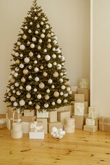 Beautifully decorated Christmas tree with many presents under it.