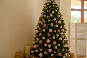 Beautifully decorated Christmas tree with many presents under it.