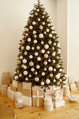 Beautifully decorated Christmas tree with many presents under it.