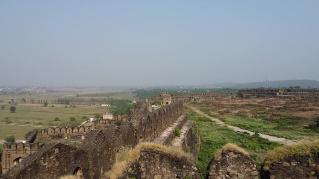 Drone flying over Langar Khani Gate of Rohtas Fort showing thick stone walls and dramatic heritage view