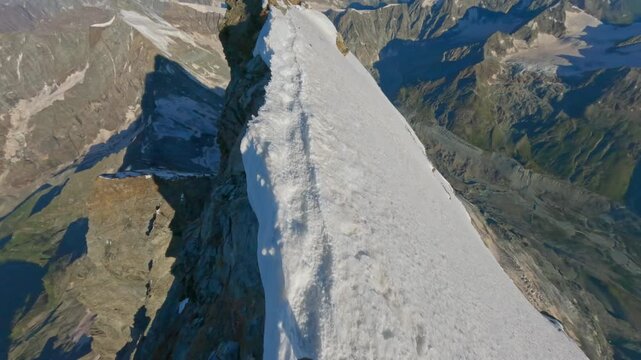 First-person POV of a climber ascending the iconic Matterhorn at sunrise on a crystal-clear bluebird day. Captured on GoPro for an immersive, realistic mountaineering experience above the clouds.