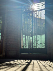Sunlight Through Metal Gate Shadows