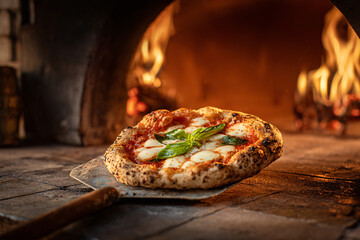 Neapolitan pizza fresh from a wood-fired oven with basil.