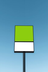 A pristine, blank advertising sign stands tall against a clear, expansive blue sky, offering ample copy space for custom messaging. The two-tiered signboard features a vibrant lime green upper panel a