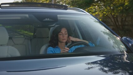 Caucasian woman driving car covering mouth while yawning feeling sleepy and exhausted during long trip. Female holding steering wheel staying alert on sunny road after tiring commute.