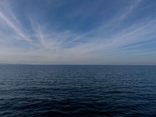 Obraz premium Calm Open Sea and Blue Sky Horizon, Peaceful Nature Landscape, Tranquil Water View, Serene Outdoor Scene
