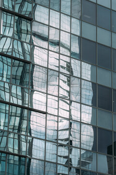 Detailed composition of glass facade reflection on modern building structure emphasizing geometry and design detail architecture captured with balanced lighting