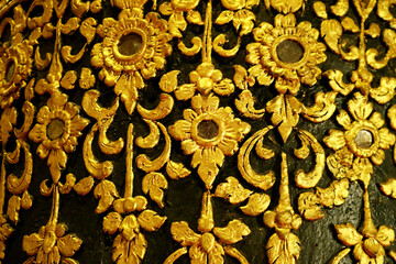 Gorgeous Gold and Black Thai Vintage Pattern on the Teak Lacquered Pillar in Wat Phumin Temple, Nan Province, Thailand