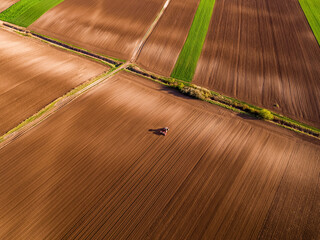 Tractor seeding agricultural field, preparing soil for planting