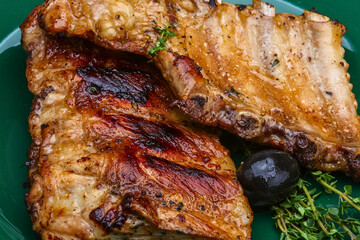 Deliciously grilled pork ribs with herbs and a dark berry garnish