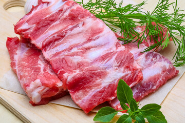 Fresh raw pork ribs ready for cooking with herbs