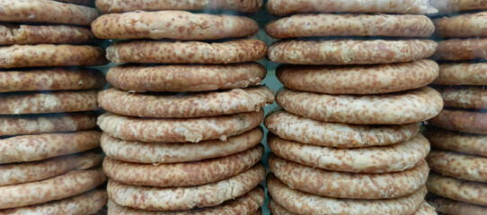 Stacked round baked goods with speckled brown and tan texture food pastry