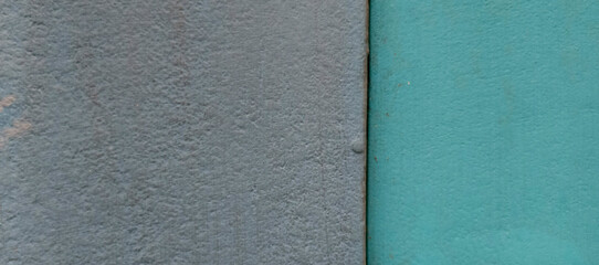 Textured gray and teal wall surface split down the middle background