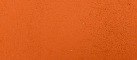Textured orange wall surface with subtle imperfections background