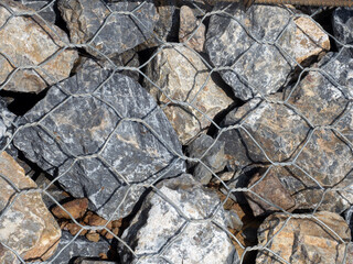 A tightly constructed wall of rocks and wire.