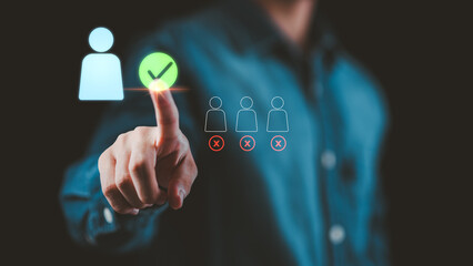 Person selecting a glowing user icon with a green check mark on digital interface, symbolizing recruitment, employee selection, human resources, and business decision-making concept.