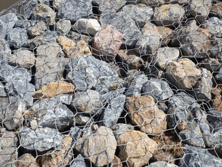 A tightly constructed wall of rocks and wire.