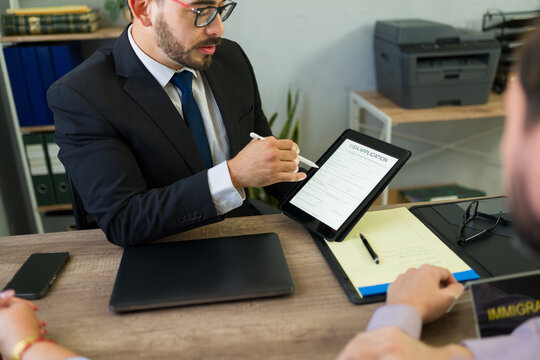 Immigration lawyer assisting client with visa application form