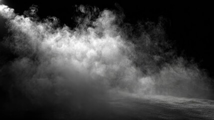 A dramatic black and white image showcasing swirling fog or smoke, creating an ethereal and mysterious atmosphere enveloped in darkness.