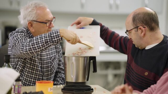 People with disabilities preparing food in a cooking class together