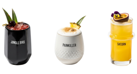 Three colorful cocktails in glasses with garnishes, isolated on transparent background
