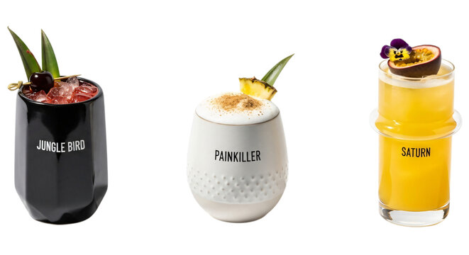 Three colorful cocktails in glasses with garnishes, isolated on transparent background