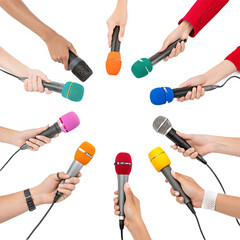 many journalist's hands holding colorful microphones in round isolated on a transparent background