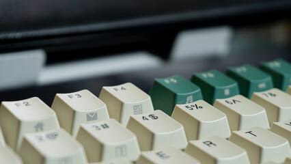 Angle view of function keys F2 to F4 on a mechanical keyboard, front keys clear and sharp while background fades into soft blur for modern product texture.