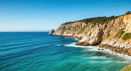 Coastal vista cliffs meet ocean under a clear blue sky, waves crashing below, sunlit
