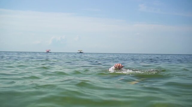 Hands of a drowning man in the sea 04