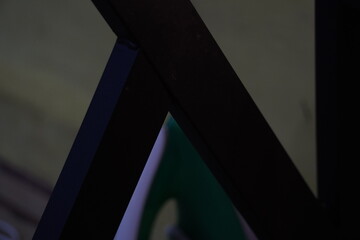 Dark abstract composition of intersecting geometric lines and shadows.