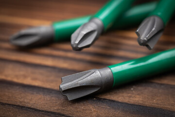 Set of bits for a screwdriver on wooden background