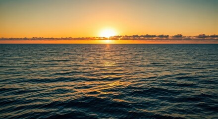 Sunrise over ocean, golden light reflecting on calm water, subtle clouds