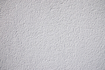 Zoom sur une façade texturée de maison peinte en grise