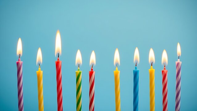 Colorful birthday candles with glowing flames, creating a festive and celebratory atmosphere.