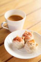 Cute Chinese Pastry or moon cake stuffed with salted egg yolk on wood plate