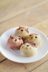 Cute Chinese Pastry or moon cake stuffed with salted egg yolk on wood plate