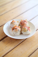 Cute Chinese Pastry or moon cake stuffed with salted egg yolk on wood plate