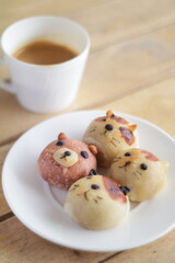 Cute Chinese Pastry or moon cake stuffed with salted egg yolk on wood plate