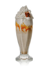 Creamy caramel milkshake topped with whipped cream and drizzled with caramel syrup. On an isolated white background.
