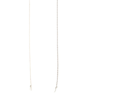 Two thin, vertical, abstract lines of differing textures against black