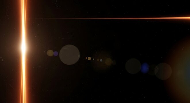 Abstract orange light streak on black background with lens flares and bokeh