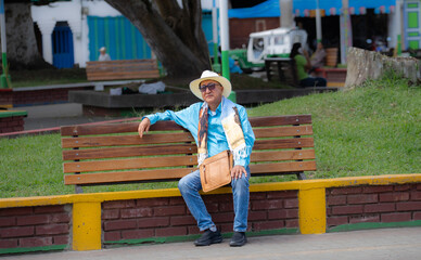 Old man sitting on bench in park