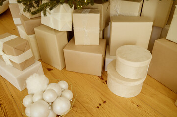 close-up of wrapped Christmas gifts lying on the floor under the Christmas tree