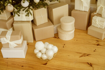 close-up of wrapped Christmas gifts lying on the floor under the Christmas tree