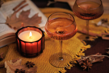 Cozy Autumn Scene with Wine Glasses and Candle