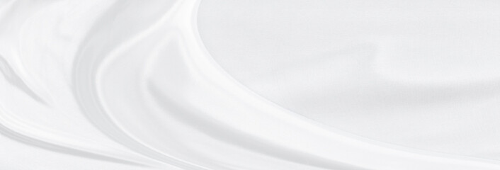 White gray satin texture that is white silver fabric silk panorama background with beautiful soft blur pattern natural.