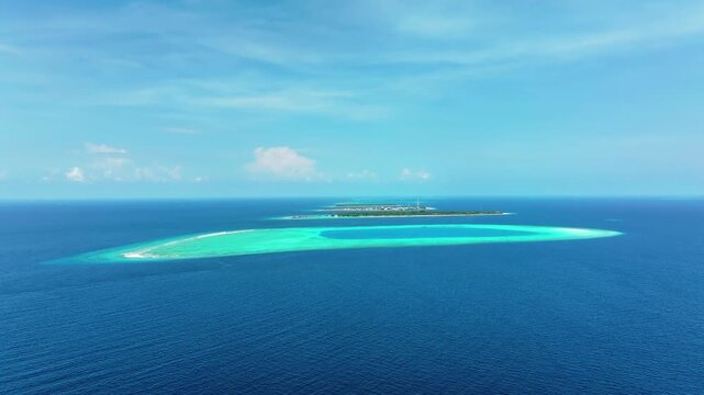 Aerial view of islands surrounded by turquoise waters, a stunning contrast to the deep blue of the ocean, Maalhos, Baa Atoll, Maldives.