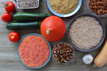 Assortment of various healthy fruits, vegetables, grains and legumes. Top view, wooden background.