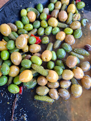 Assorted marinated olives and capers create a flavorful appetizer platter ideal for gatherings and Mediterranean cuisine.
